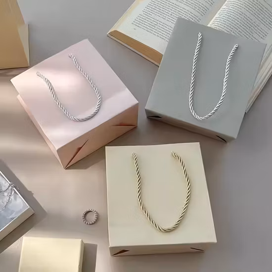 Saco de papel Kraft para compras de presentes de luxo barato por atacado de fábrica OEM com logotipo personalizado